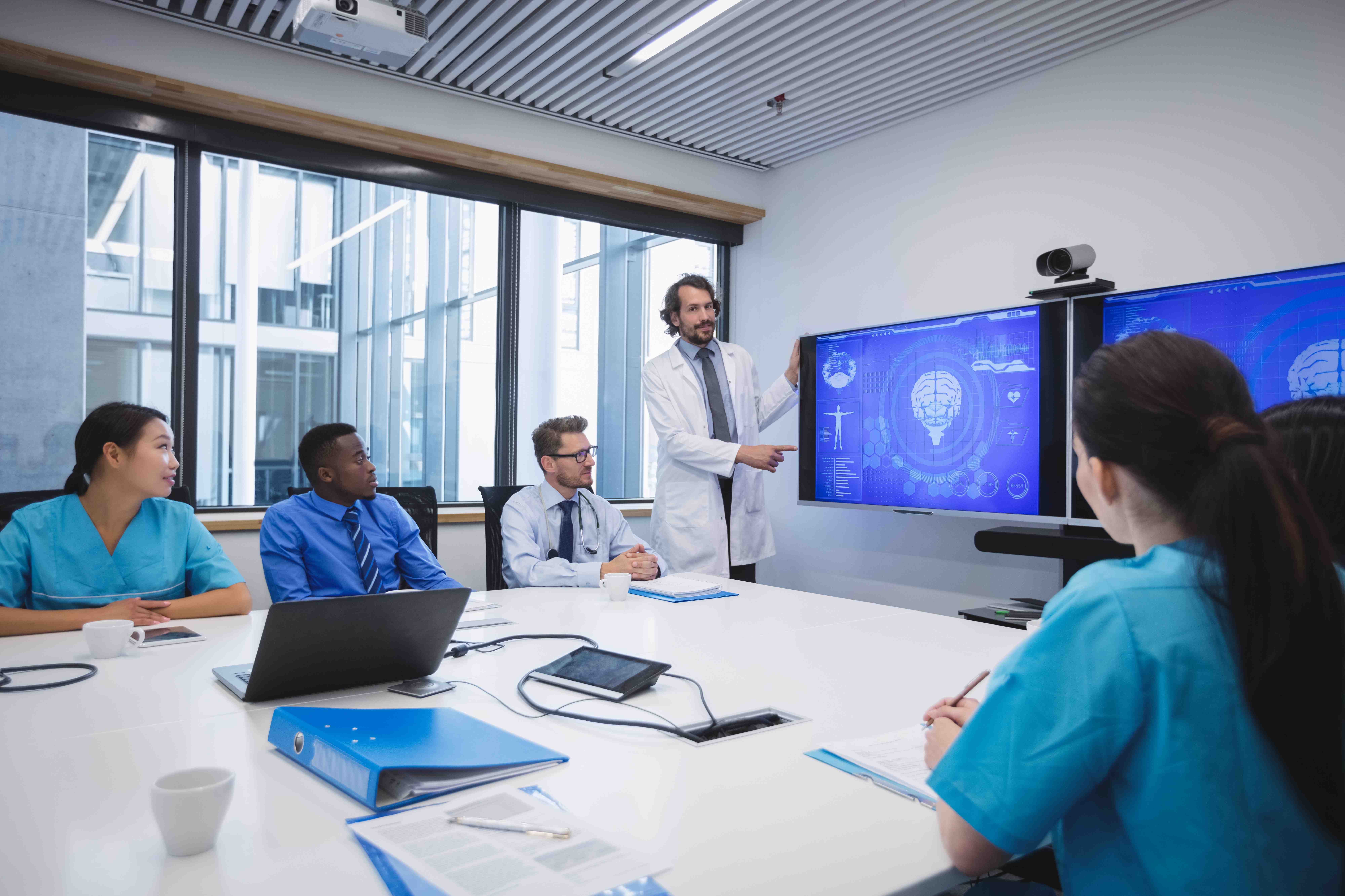Medical professionals in a meeting using technology